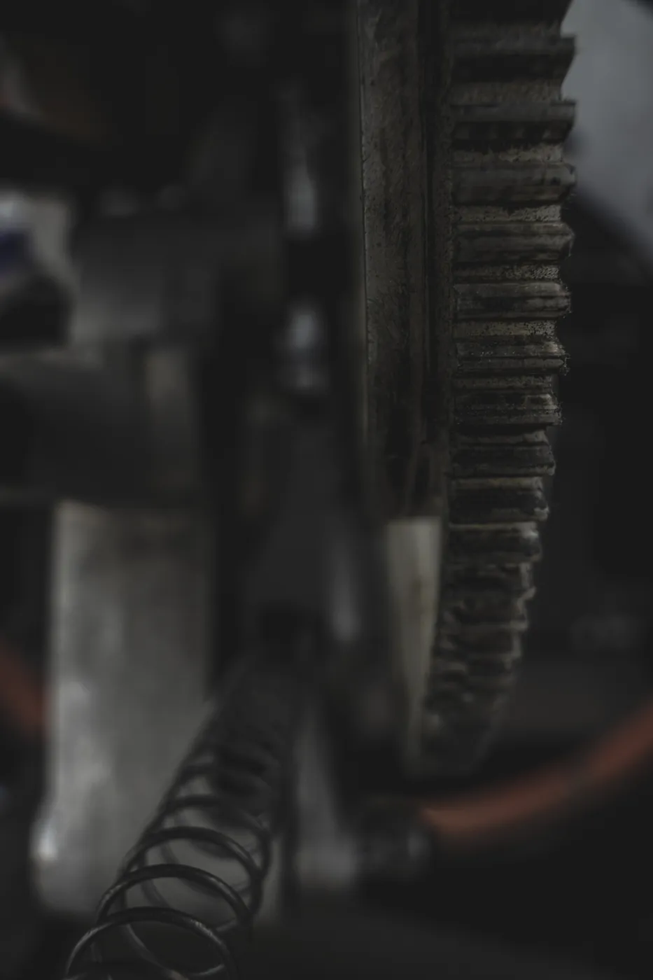 Abstract close-up of vintage gears and springs in shadow