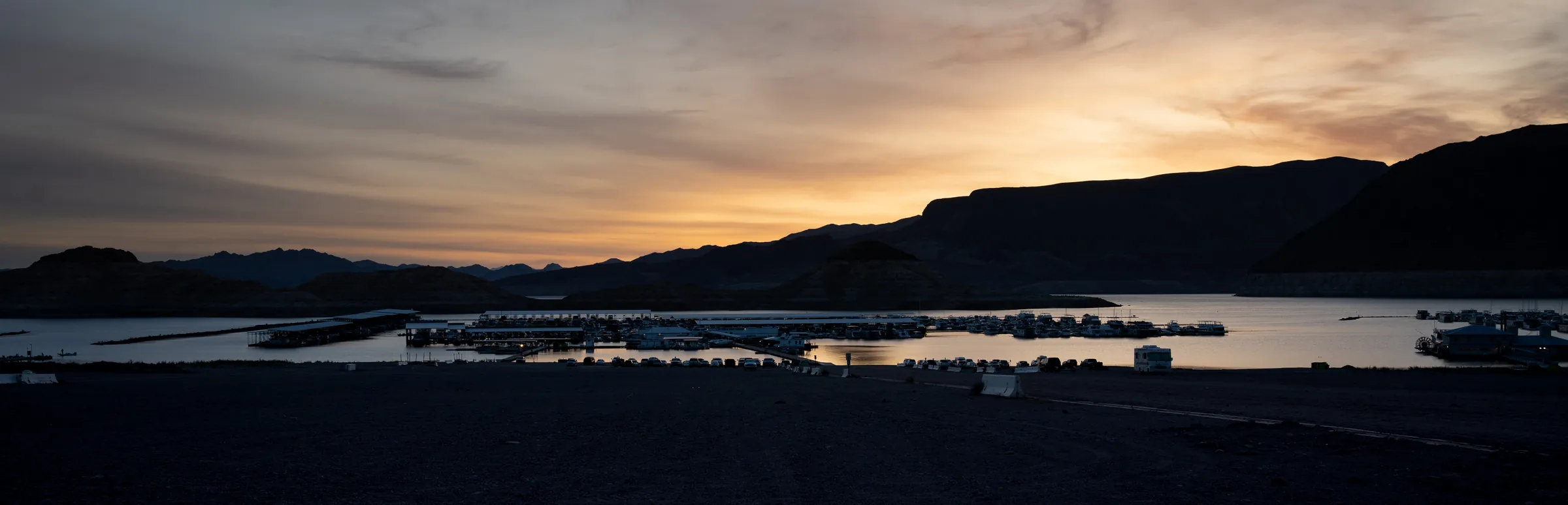 Panoramic dusk view of desert mountains and a lake horizon in Southern Nevada